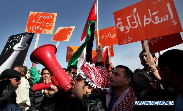 Jordanian protestors shout slogans during a sit-in held outside the prime minister's office in Amman, Jordan, on Jan. 29, 2011, calling for the formation of an interim government and the resignation of the government of Prime Minister Samir Rifai.[Mohammad Abu Ghosh/Xinhua]