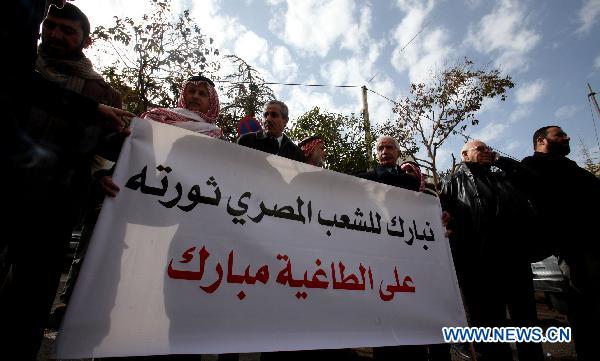 Jordanian activists hold a banner in support of the ongoing protests in Egypt against Hosni Mubarak's regime during a sit-in held in front of the Egyptian embassy in Amman, Jordan, on Jan. 29, 2011. [Mohammad Abu Ghosh/Xinhua]