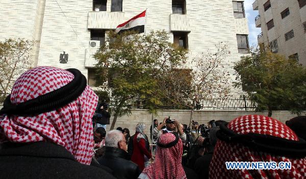 Jordanian activists stand in front of the Egyptian embassy during a sit-in in support of the ongoing protests in Egypt against Hosni Mubarak's regime held in Amman, Jordan, on Jan. 29, 2011.[Mohammad Abu Ghosh/Xinhua]