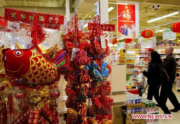 Customers walk among the goods for the upcoming Chinese Lunar New Year, or the Spring Festival, at a Chinese supermarket in Toronto, Canada, Jan. 28, 2011.