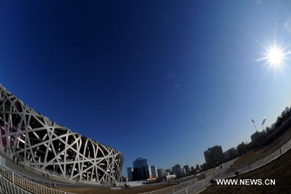 Photo taken on Jan. 29, 2011 shows the National Stadium, also known as the 'Bird's Nest' in the sun in Beijing, capital of China. Beijing breaked a 60-year record for the latest date for its first snowfall of the season on Saturday. Since 1951, the latest record of the first snowfall in Beijing was in 1984, when it arrived on Jan. 29. (Xinhua/Gong Lei) (ly) 