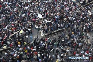 Demonstrators gather near the main Tahrir Square in Cairo, Egypt, Jan. 29, 2011. Tens of thousands of Egyptians defied a curfew and remained on the streets of downtown Cairo on Saturday, demanding the ouster of President Hosni Mubarak. [Cai Yang/Xinhua]