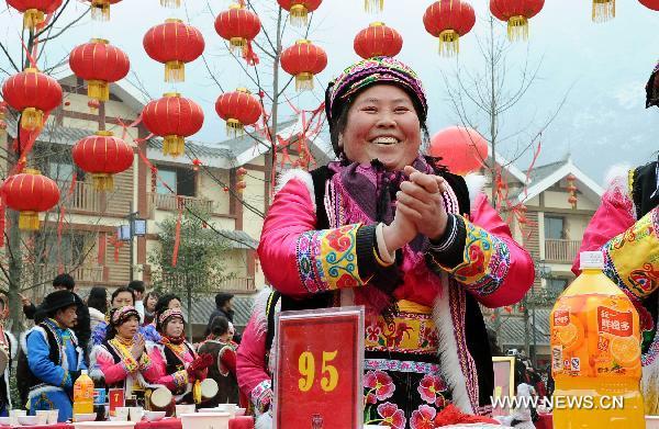 A woman smiles on a grand public banquet to celebrate the coming Spring Festival in Yingxiu Town of Wenchuan County, southwest China's Sichuan Province, Jan. 31, 2011.[Chen Kai/Xinhua]