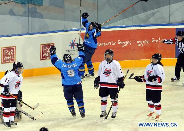 Olga Potapova (2nd L) of Kazakhstan celebrates the goal during their women's ice hocky tournament against Japan at the 7th Asian Winter Games in Almaty, Kazakhstan, Jan. 31, 2011.