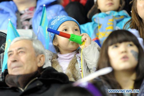 A local girl watches the women's ice hocky tournament between Kazakhstan and Japan at the 7th Asian Winter Games in Almaty, Kazakhstan, Jan. 31, 2011. 