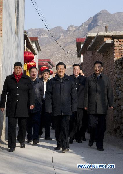 Chinese President Hu Jintao (C) visits Shijiatong Village, Xishanbei Township of Baoding City, north China's Hebei Province, Feb. 2, 2011. Hu made a tour in Baoding from Feb. 1 to 2 to welcome the Spring Festival, or China's Lunar New Year, with local officials and residents.