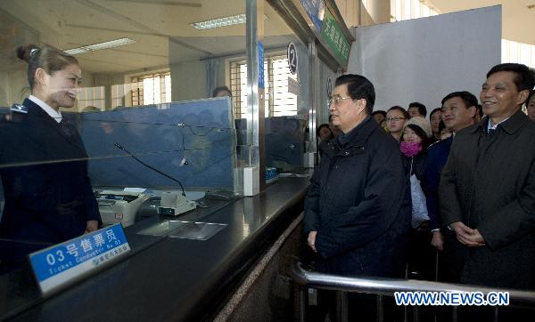 Chinese President Hu Jintao (2nd R front) inquires the information on the sale of tickets during Spring Festival travel rush in front of the ticket booth as he visits a long-distance coach station in Baoding City, north China's Hebei Province, Feb. 1, 2011. Hu made a tour in Baoding from Feb. 1 to 2 to welcome the Spring Festival, or China's Lunar New Year, with local officials and residents.