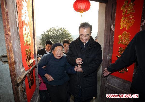 Chinese Premier Wen Jiabao (R) holds the hand of a villager as he visits Zhaoyuan Village, Taoling Town of Jinzhai County, east China's Anhui Province, Feb. 1, 2011. Wen made a tour Tuesday in Jinzhai County in the Dabie Mountains area, former revolutionary base, to know about local economic and social development, and spend the Spring Festival holiday with local officials and residents.