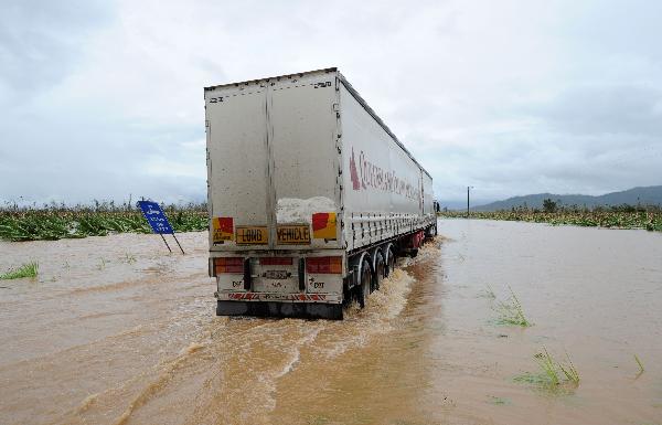 A truck drives down the flooded Bruce Highway after Cyclone Yasi tore through Tully on February 3, 2011. Australia's worst cyclone in a century devastated towns and left 175,000 people without power, but miraculously no deaths were reported as police scoured worst-hit areas.