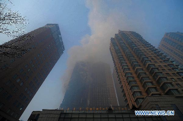 Photo taken on Feb. 3, 2011 shows the smoked Dynasty Wanxin building complex in Shenyang, capital of northeast China's Liaoning Province. Fire gutted Thursday the building complex in Shenyang. No casualties had been found, according to local officials. Police said the fire was triggered by fireworks, which accidentally sparked off the external wall of the buildings. Further investigation into the cause and losses of the fire is still underway.