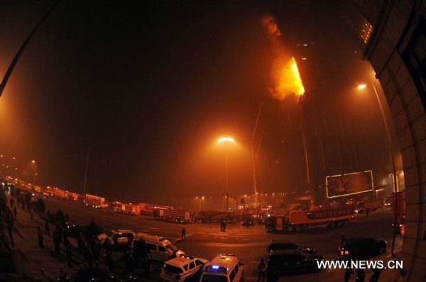 Blaze is seen at a building in Shenyang, northeast China's Liaoning Province, Feb. 3, 2011. Initial investigation shows the fire was caused by fireworks while people were celebrating the Lunar New Year. The fire is currently under control with no casualty reported yet.