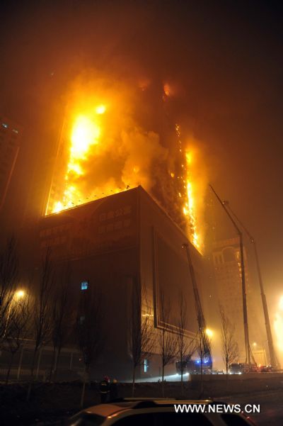 Blaze is seen at a building in Shenyang, northeast China's Liaoning Province, Feb. 3, 2011. Initial investigation shows the fire was caused by fireworks while people were celebrating the Lunar New Year. The fire is currently under control with no casualty reported yet.