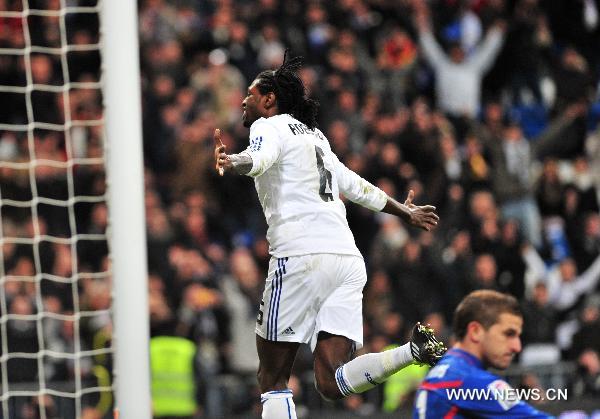 Real Real Madrid's Emmanuel Adebayor (top) celebrates past Sevilla's goalkeeper Javier Varas after scoring during the Spanish King's Cup semifinal second-leg football match between Real Madrid and Sevilla at the Santiago Bernabeu stadium in Madrid, capital of Spain, Feb. 2, 2011. Real Madrid won 2-0.