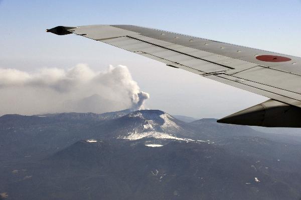 An aerial view from the window a commercial aircraft on February 3, 2011 shows smoke rising from the crater of Mount Shinmoedake in the Kirishima mountain range in Kagoshima prefecture, on Japan's southern island of Kyushu.