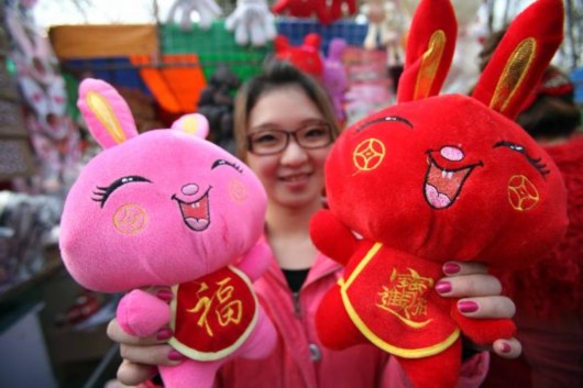A girl displays 'bunny dolls' at the Spring Festival cultural temple fair held in Ditan Park, Beijing, capital of China, Feb. 2, 2011. Variety of goods related to bunny are well received by visitors at temple fairs kicked off in Beijing on Wednesday, the Chinese Lunar New Year's Eve. 