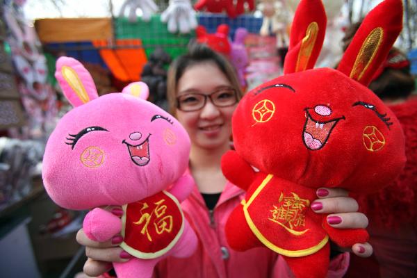 A girl displays 'bunny dolls' at the Spring Festival cultural temple fair held in Ditan Park, Beijing, capital of China, Feb. 2, 2011. Variety of goods related to bunny are well received by visitors at temple fairs kicked off in Beijing on Wednesday, the Chinese Lunar New Year's Eve. [Xinhua]