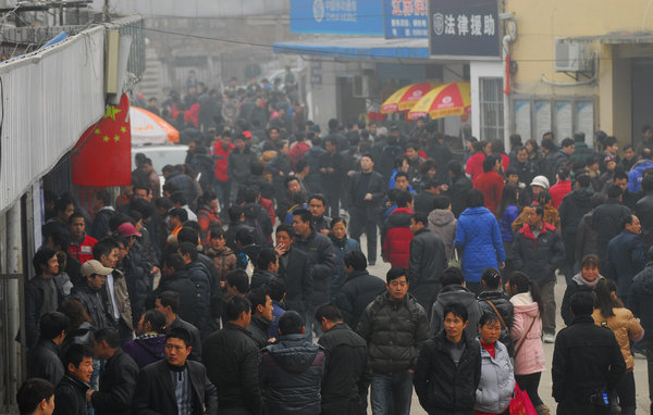 Migrant workers return to Nanjing, Jiangsu Province, early during the Spring Festival to look for jobs at the Andemen migrant workers' job market, Tuesday, Feb. 8, 2011. More than 2,000 migrant workers from all over the region have come to the Andemen job market to find jobs. 