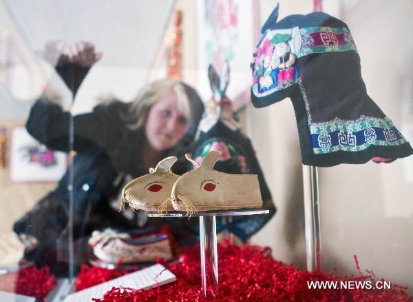 A visitor looks at the rabbit-shaped shoes during an exhibition at the Bata Shoe Museum in Toronto, Canada, Feb. 8, 2011. A 40-day-long exhibition featuring rabbit-shaped Chinese shoes is on show at the Bata Shoe Museum to celebrate the Chinese Lunar New Year, the year of Rabbit. 