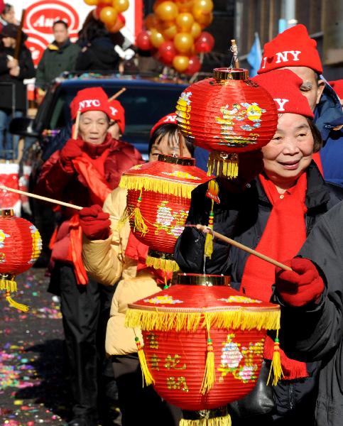 Local overseas Chinese participate in the Chinese New Year parade to celebrate the Chinese Lunar New Year, the Year of the Rabbit, in Chinatown of New York, the United States, Feb. 6, 2011. 