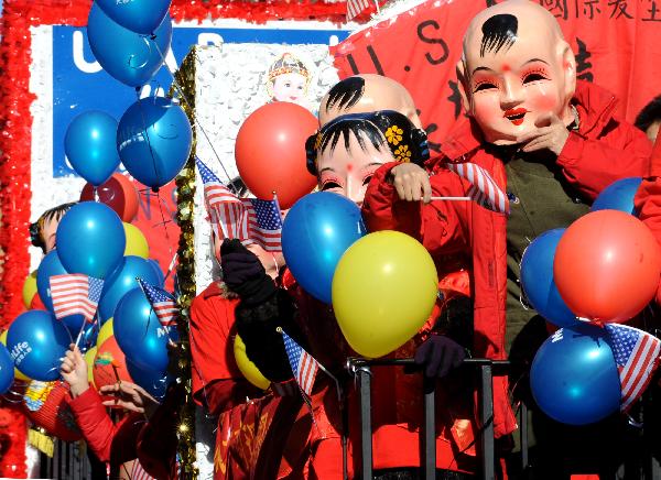 Local overseas Chinese participate in the Chinese New Year parade to celebrate the Chinese Lunar New Year, the Year of the Rabbit, in Chinatown of New York, the United States, Feb. 6, 2011. 