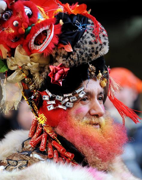 A man participates in the Chinese New Year parade to celebrate the Chinese Lunar New Year, the Year of the Rabbit, in Chinatown of New York, the United States, Feb. 6, 2011. 