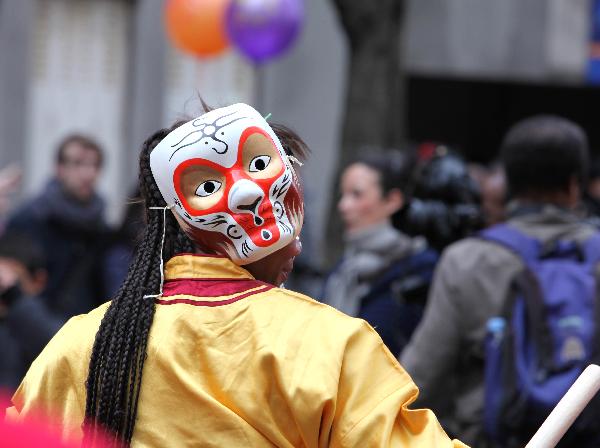 A woman wearing a monkey facial mask participates in the annual Chinese Spring Festival Parade in Paris, capital of France, Feb. 6, 2011. Chinese French associations organized on Sunday the annual parade to celebrate the Chinese Lunar New Year, the Year of the Rabbit. 