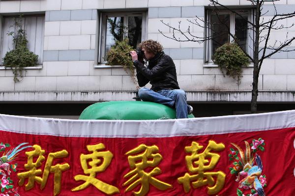 A photgrapher shoots pictures of the annual Chinese Spring Festival Parade in Paris, capital of France, Feb. 6, 2011. Chinese French associations organized on Sunday the annual parade to celebrate the Chinese Lunar New Year, the Year of the Rabbit.