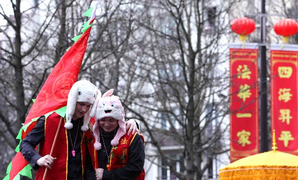 A couple participate in the annual Chinese Spring Festival Parade in Paris, capital of France, Feb. 6, 2011. Chinese French associations organized on Sunday the annual parade to celebrate the Chinese Lunar New Year, the Year of the Rabbit. 