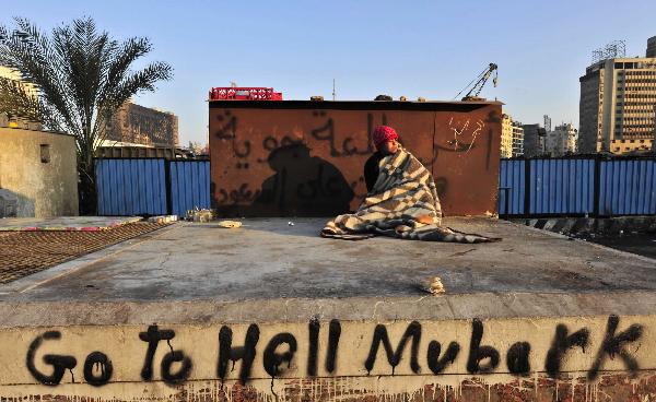  A demonstrator wakes up at Tahrir Square in Cairo, capital of Egypt, Feb. 8, 2011. Demonstrations demanding resign of President Hosni Mubarak continued, though the new government approved 15-percent pay raise for government employees. 