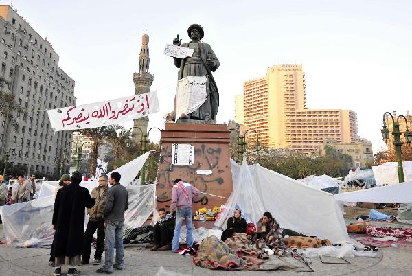 Demonstrators wake up at Tahrir Square in Cairo, capital of Egypt, Feb. 8, 2011. Demonstrations demanding resign of President Hosni Mubarak continued, though the new government approved 15-percent pay raise for government employees.