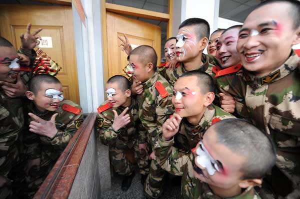 Soldiers of the armed police in Huaibei, Anhui province, learn to sing Yu Opera, a major local opera in Henan province that enjoys nationwide popularity, on Monday. Professional performers were invited to coach the new soldiers during the Spring Festival holidays. [Photo/Xinhua]