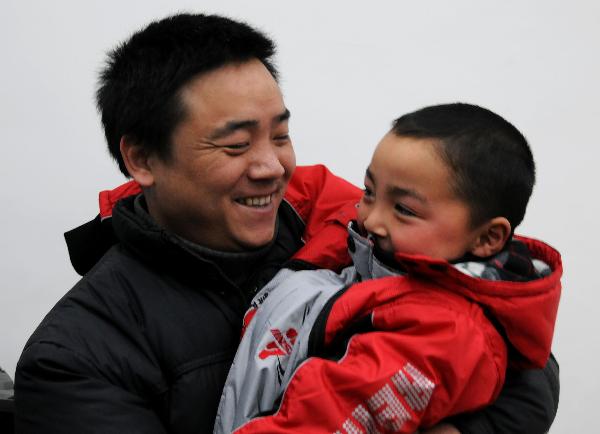 Peng Gaofeng holds his lost son Peng Wenle in his arms in Pizhou, east China&apos;s Jiangsu Province, Feb. 9, 2011. [Xinhua] 