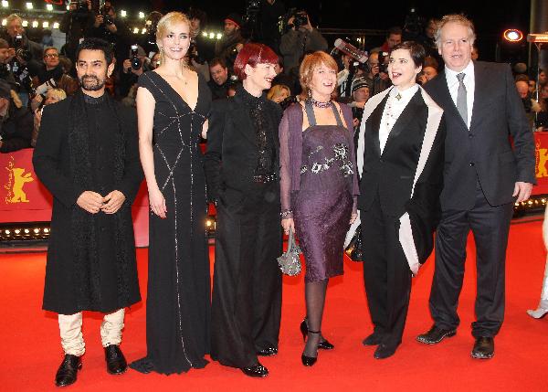 Jury members (from L to R) Indian actor Aamir Khan, German actress Nina Hoss, British costume designer Sandy Powell, Australian producer Jan Chapman Italian actress and jury president Isabella Rossellini and Canadian producer Guy Maddin pose on the red carpet for the premiere of the film 'True Grit' by U.S.