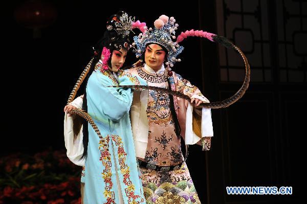 Jinju Opera performers Song Meijuan (L) and Li Hongmei (R) act during a folk drama performance in Taiyuan, capital of north China's Shanxi Province, Feb. 11, 2011.