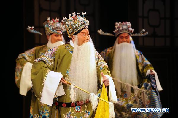 Wu Zhong (front), 73-year-old Jinju Opera performer, acts during a folk drama performance in Taiyuan, capital of north China's Shanxi Province, Feb. 11, 2011.