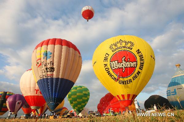 Hot-air balloons are inflated during the 16th Philippine International Hot-Air Balloon Fiesta at the Clark Freeport Zone in Pampanga, north of Manila, the Philippines, Feb. 10, 2011.