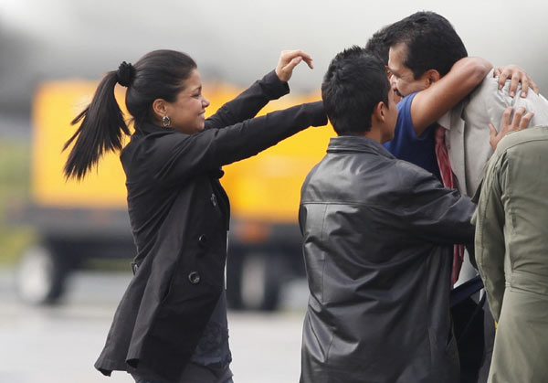 Politician Armando Acuna (R) embraces his relatives upon his arrival at Catam airport in Bogota February 11, 2011. Revolutionary Armed Forces of Colombia (FARC) rebels on Friday released kidnapped local politician Acuna and captive marine Henry Lopez to a Red Cross team who flew into the country's southern jungles in the latest rebel hostage handover. [Xinhua] 