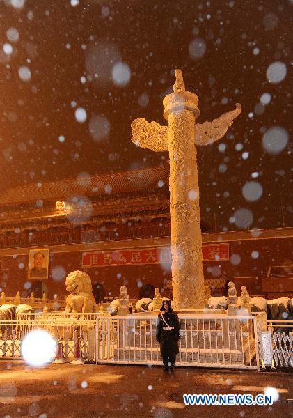 An armed policeman is seen in the Tian&apos;anmen Square in Beijng, capital of China, Feb. 13, 2011. Beijing embraced the second snowfall this winter since Saturday night. 