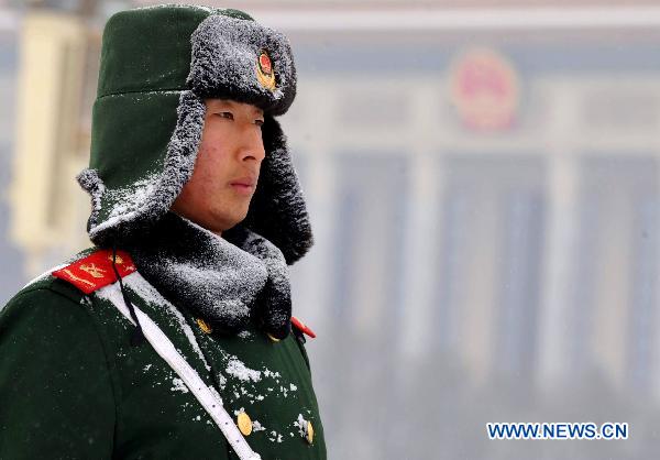 An armed policeman stands guard in the Tian'anmen Square in Beijing, capital of China, Feb. 13, 2011. Beijing embraced the second snowfall this winter since Saturday night. 