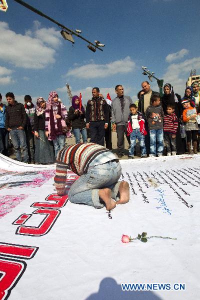 A man writes victims&apos; names on a giant poster at Tahrir Square in Cairo, Egypt, Feb. 12, 2011. People continued celebrating the resignation of Egyptian President Hosni Mubarak on Tahrir Square Saturday. Egypt&apos;s President Hosni Mubarak stepped down and the military took charge of the country, Egypt&apos;s Vice President Omar Suleiman said on Friday afternoon. [Xinhua] 