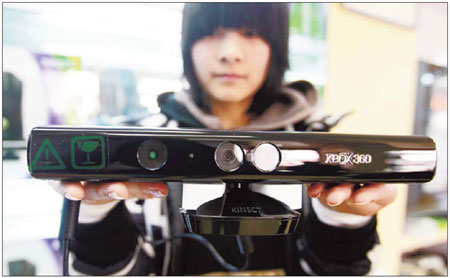 A woman holds a Kinect console at a shop in Gulou Dongdajie in downtown Beijing, a 1,098-meter street frequented by console game enthusiasts who travel there to buy the latest on-screen craze from the many specialist shops. The road that leads up to the tourist site of the Drum and Bell towers is known as the capital's console game street. [China Daily]