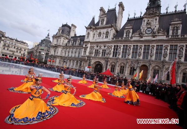 Chinese dancers perform in front of the City Hall of Paris, capital of France, Feb. 13, 2011. Overseas Chinese in France organized a grand performance here on Sunday as part of the celebrations of the Chinese Lunar New Year of Rabbit. [Gao Jing/Xinhua]
