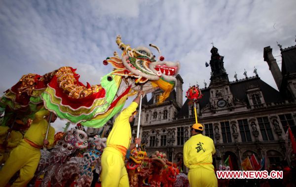 Local Chinese perform dragon dance in front of the City Hall of Paris, capital of France, Feb. 13, 2011. Overseas Chinese in France organized a grand performance here on Sunday as part of the celebrations of the Chinese Lunar New Year of Rabbit. [Gao Jing/Xinhua]