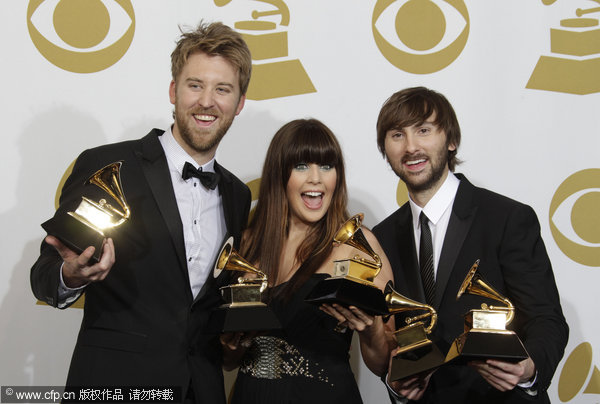 (From the left) Members of the country trio Lady Antebellum Charles Kelley, Hillary Scott and Dave Haywood pose backstage with the award for best record of the year at the 53rd Annual Grammy Awards on Sunday, Feb. 13, 2011, in Los Angeles. 