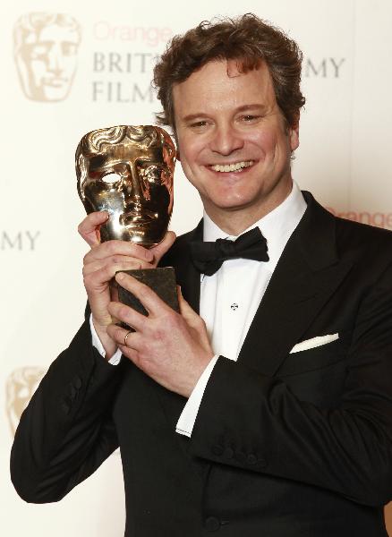 British actor Colin Firth poses for photographers with his British Academy of Film Award (BAFTA) for 'Leading Actor' in 'The King's Speech' at the Royal Opera House in central London.