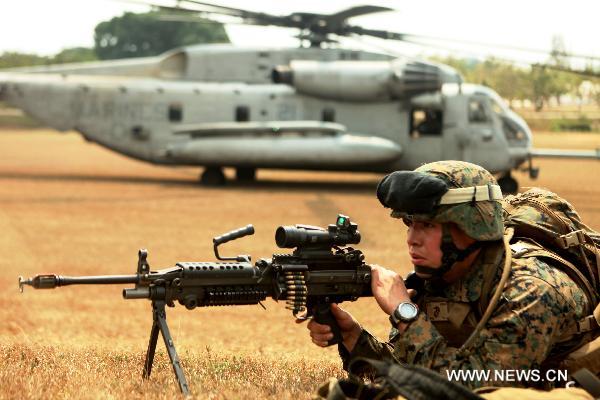 An infantryman provides cover fire for a helicopter during a mock helo raid of Exercise Cobra Gold 2011 in Samesan, Thailand, on Feb. 13, 2011. Cobra Gold 2011 marks the 30th anniversary of the exercise, which focuses on basic military skills training, staff planning and humanitarian and civic assistance projects.[Xinhua/Pr. Photo Cobra Gold 2011]