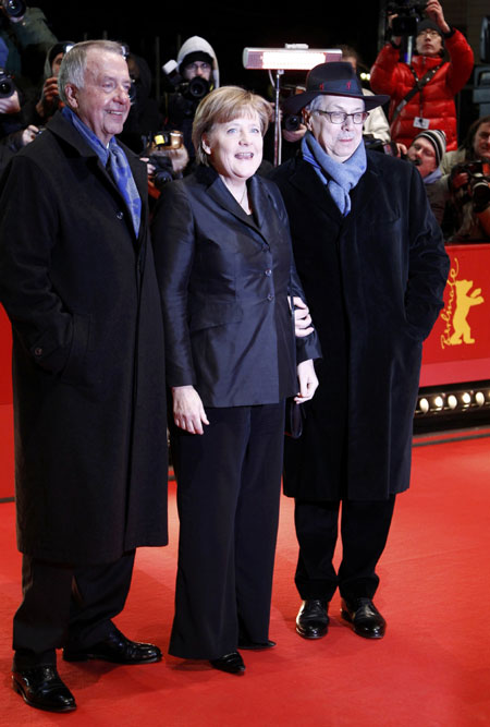 State Minister for Culture and Media Bernd Neumann (L), Berlinale festival director Dieter Kosslick (R) and German Chancellor Angela Merkel arrive at the red carpet for the movie 'Pina' at the 61st Berlinale International Film Festival in Berlin February 13, 2011. The Berlinale International Film Festival runs from February 10 to 20, 2011.