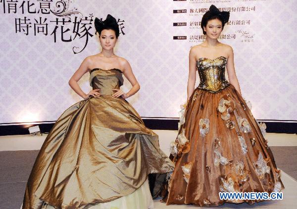 Chinese mainland models present wedding dresses during a fashion show at the ongoing International Flower Expo in Taipei, southeast China's Taiwan, Feb. 15, 2011.