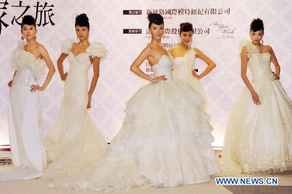 Chinese mainland models present wedding dresses during a fashion show at the ongoing International Flower Expo in Taipei, southeast China's Taiwan, Feb. 15, 2011.