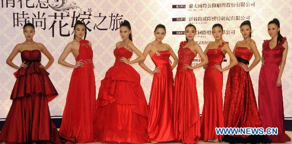 Chinese mainland models present wedding dresses during a fashion show at the ongoing International Flower Expo in Taipei, southeast China's Taiwan, Feb. 15, 2011.